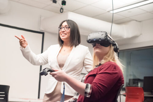 image of Prof. Rosalba Hernandez with student using virtual reality goggles