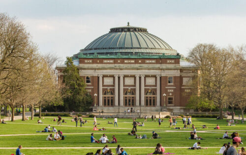 Early spring view of the Quad with students enjoying the weather.