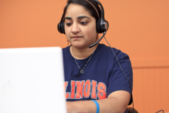 student using laptop and wearing headset