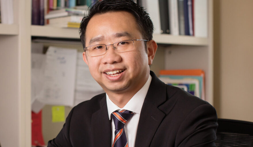 headshot of Kevin Tan in office