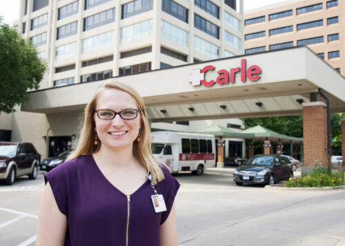 student intern standing in front of Carle hospital in Urbana IL