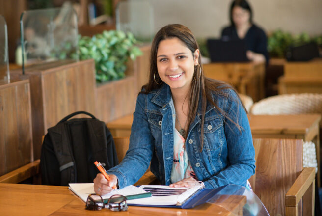 female student in cafe doing homework