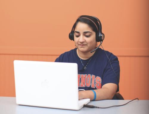 student using computer and wearing headphones