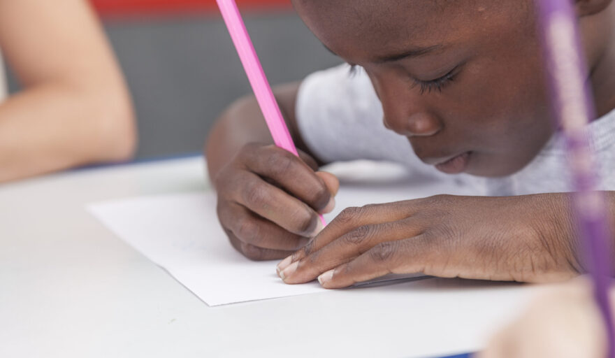 african american child drawing at desk