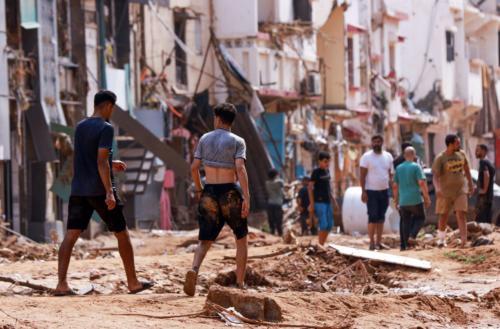  People check an area damaged by flash floods in Derna, Libya, on Monday. AFP via Getty Images 