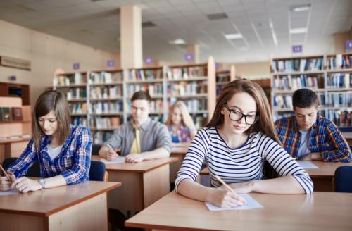 stock image of students taking survey in library setting