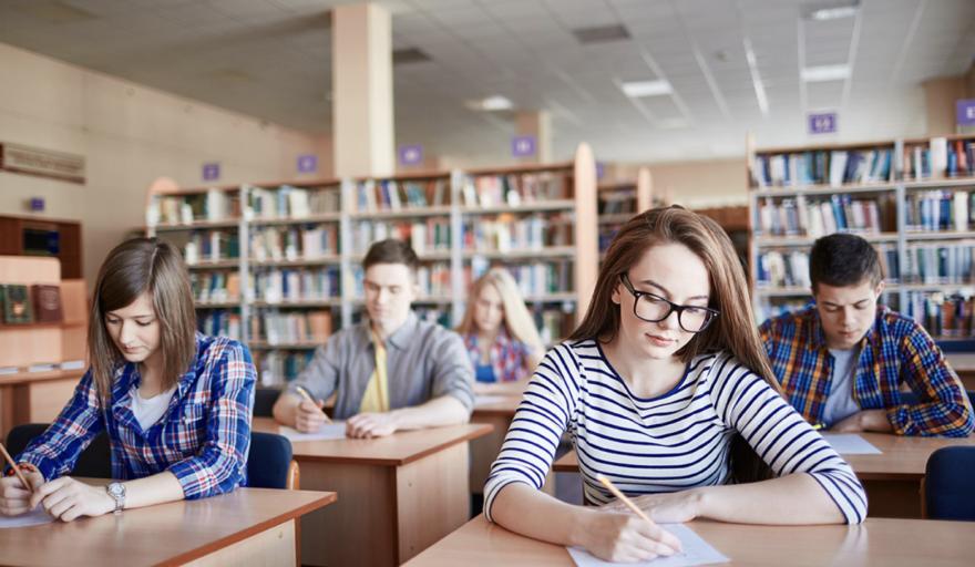 stock image of students taking survey in library setting