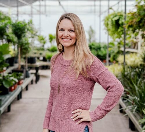 Amy Dean standing near plants