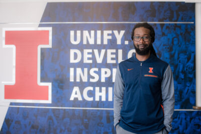 DJ Taylor in front of Illinois Athletics sign