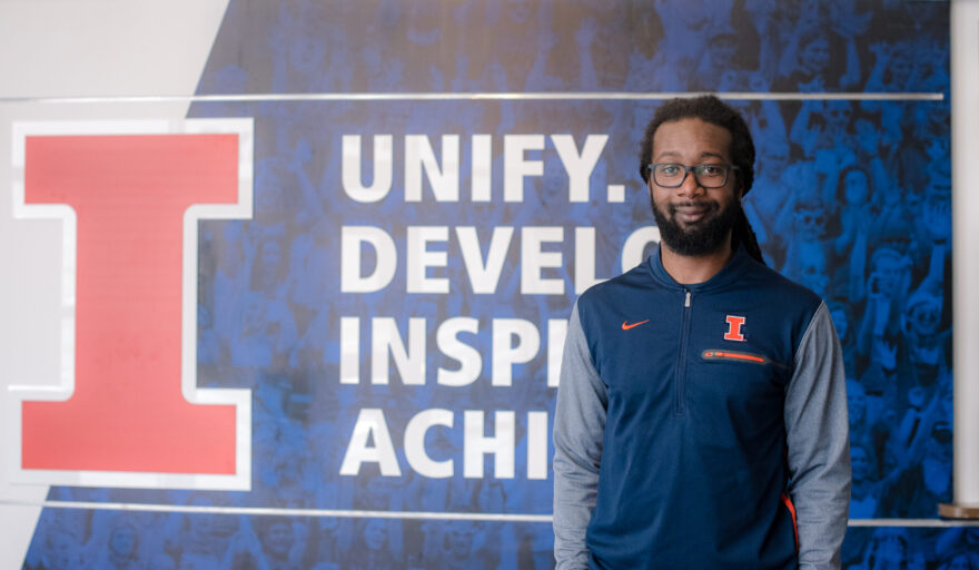 DJ Taylor in front of Illinois Athletics sign