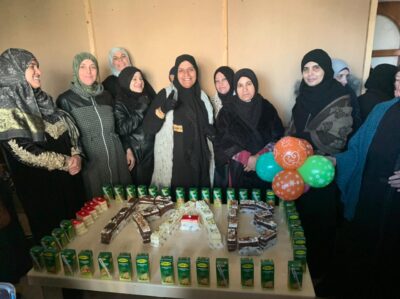 group of women standing together around a table