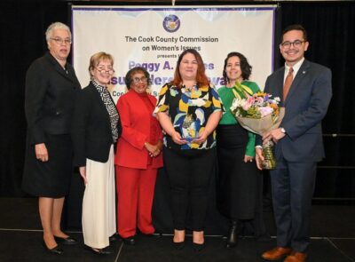 photo of April Curtis holding award with other attendees