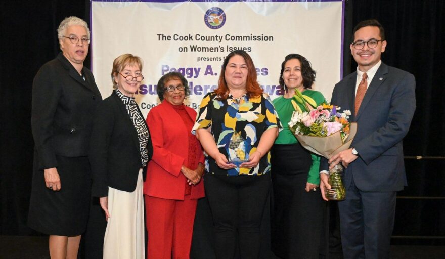 photo of April Curtis holding award with other attendees